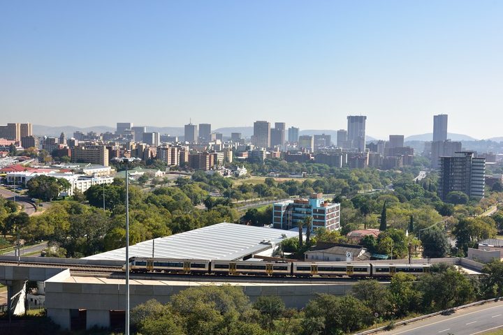 Pretoria seen from above: office towers, trees and freeway embankments across the city bowl